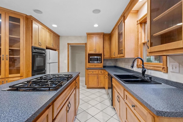 928 Emilie St, Green Bay, WI 54301 - kitchen with black appliances, light tile patterned floors, dark countertops, recessed lighting, and glass insert cabinets