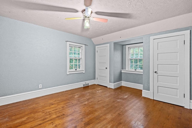 928 Emilie St, Green Bay, WI 54301 - unfurnished bedroom with hardwood / wood-style floors, a textured wall, a textured ceiling, and ceiling fan