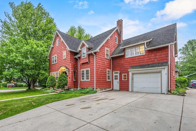 928 Emilie St, Green Bay, WI 54301 - view of front facade with a chimney, an attached garage, concrete driveway, roof with shingles, and a front yard