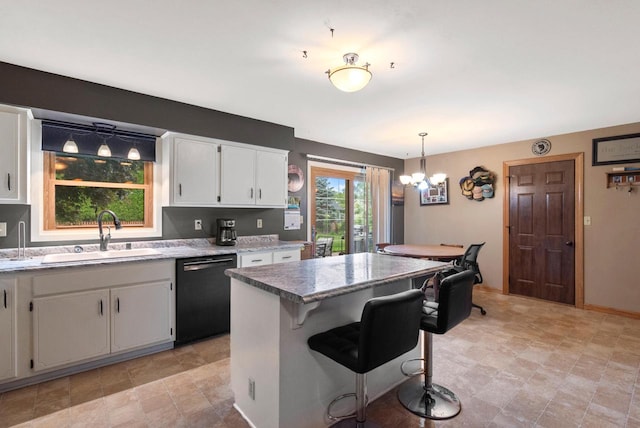3987 Elaines Way, Slinger, WI 53086 - kitchen featuring black dishwasher, a chandelier, white cabinets, a kitchen bar, and a center island