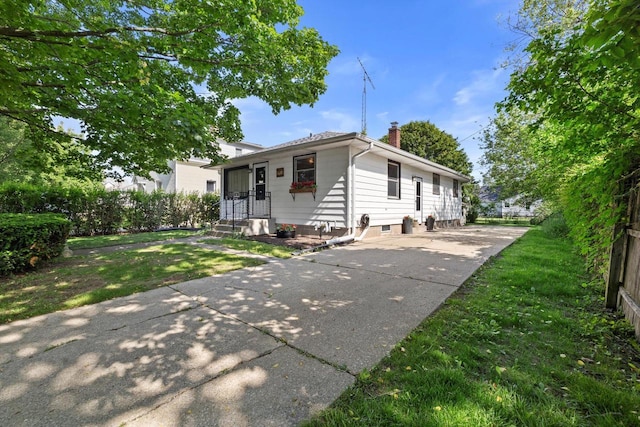 1416 Plainfield Ave, Mount Pleasant, WI 53403 - view of front of home with a chimney, a front yard, and concrete driveway