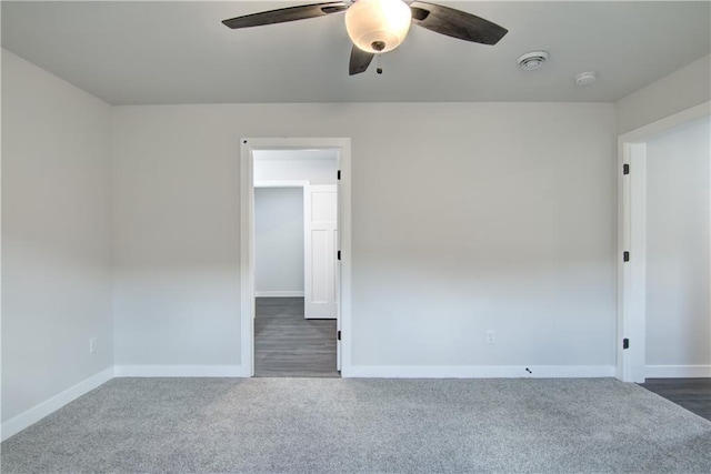 1688 Dorret Rd, Eau Claire, WI 54703 - empty room featuring a ceiling fan, dark carpet, and a smoke detector