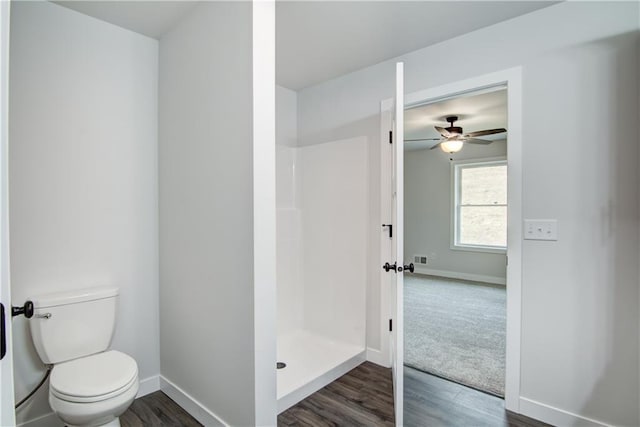 1688 Dorret Rd, Eau Claire, WI 54703 - bathroom with a stall shower, wood finished floors, and a ceiling fan