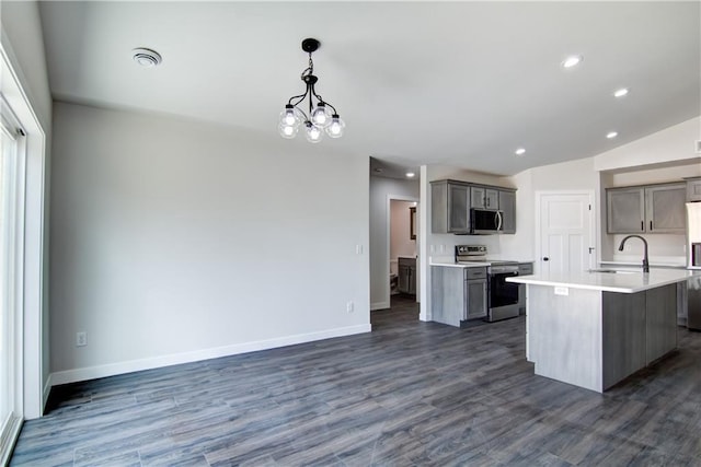 1688 Dorret Rd, Eau Claire, WI 54703 - kitchen with appliances with stainless steel finishes, gray cabinets, dark wood-style floors, a center island with sink, and recessed lighting