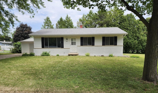 1239 Erick St, Fort Atkinson, WI 53538 - ranch-style house featuring brick siding, a front lawn, and a chimney