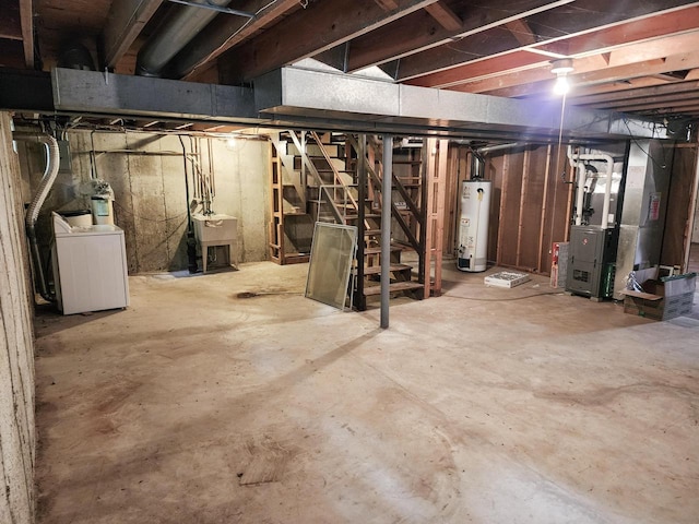 1239 Erick St, Fort Atkinson, WI 53538 - unfinished below grade area with washer / clothes dryer, gas water heater, heating unit, and stairway