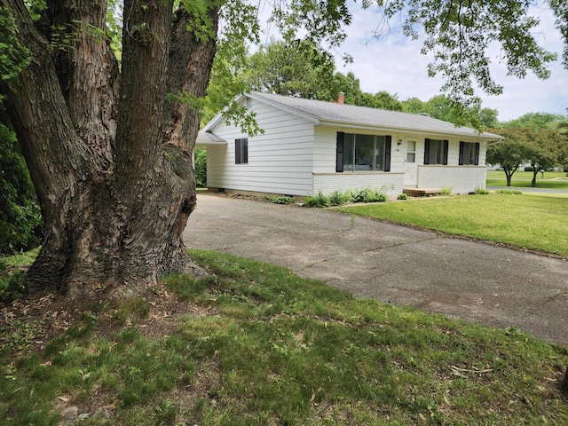 1239 Erick St, Fort Atkinson, WI 53538 - ranch-style house with driveway, a front yard, brick siding, and a chimney