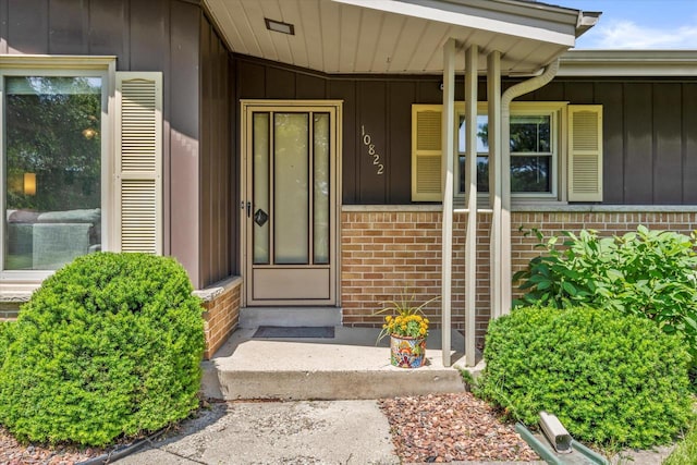10822 W Derby Ave, Wauwatosa, WI 53225 - property entrance with board and batten siding, brick siding, and covered porch