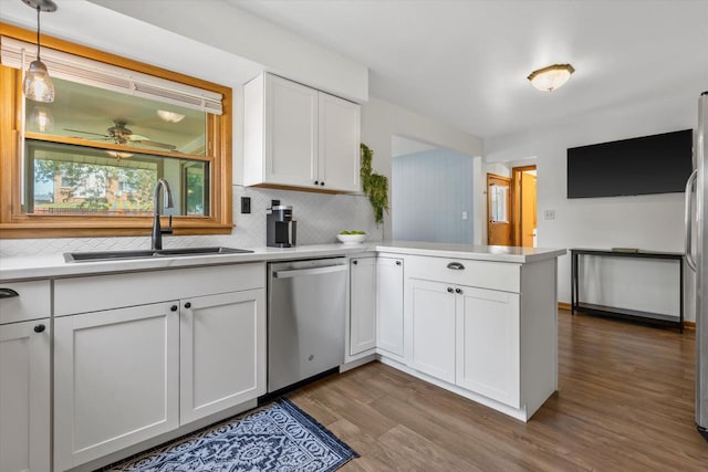 10822 W Derby Ave, Wauwatosa, WI 53225 - kitchen with dishwasher, a peninsula, tasteful backsplash, and wood finished floors