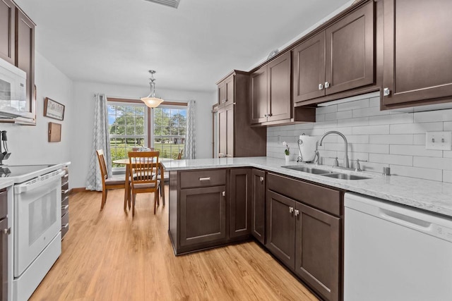 2524 Village Ln Unit B, Oshkosh, WI 54904 - kitchen with white appliances, dark brown cabinets, decorative backsplash, and light wood finished floors