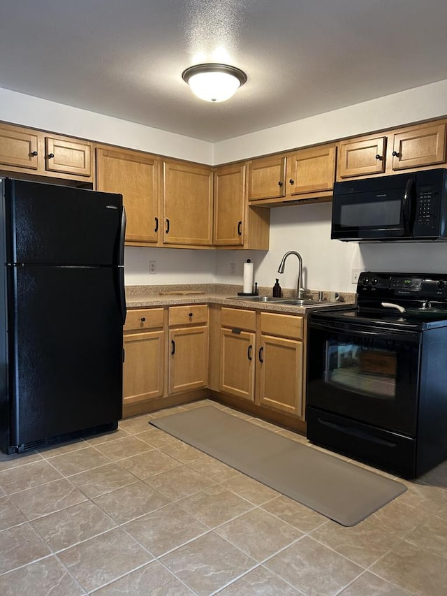 1106 S 7th St, Sheboygan, WI 53081 - kitchen with black appliances, brown cabinets, and light tile patterned floors