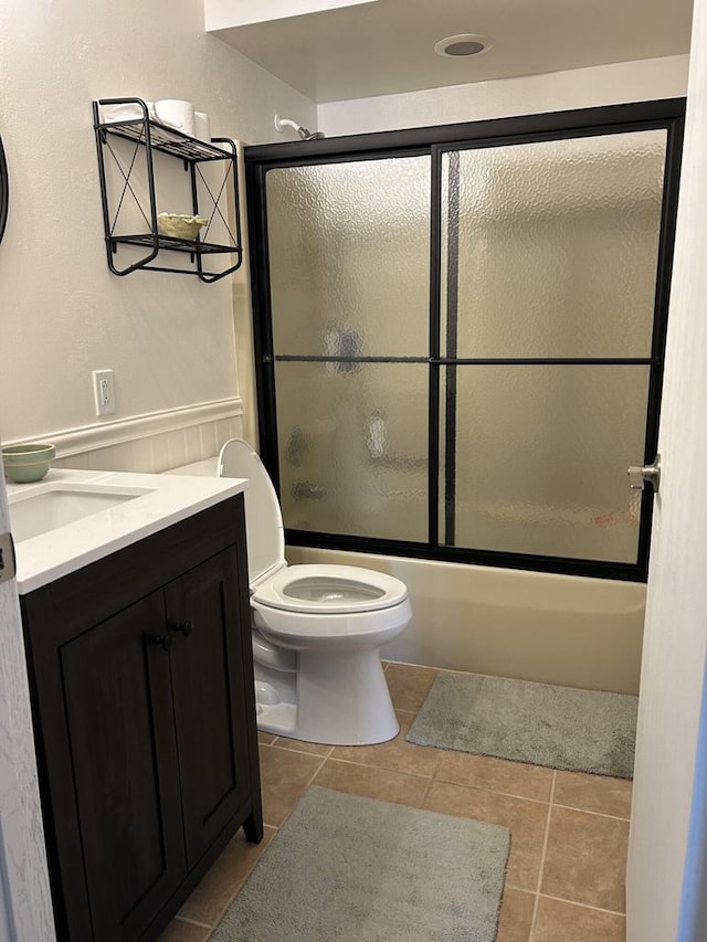 1106 S 7th St, Sheboygan, WI 53081 - full bathroom featuring vanity, enclosed tub / shower combo, tile patterned floors, and wainscoting