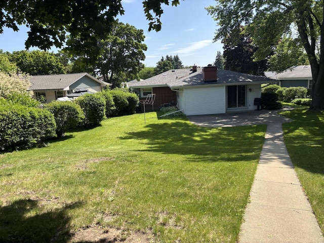 9035 W Burdick Ave, Milwaukee, WI 53227 - view of green lawn featuring a patio