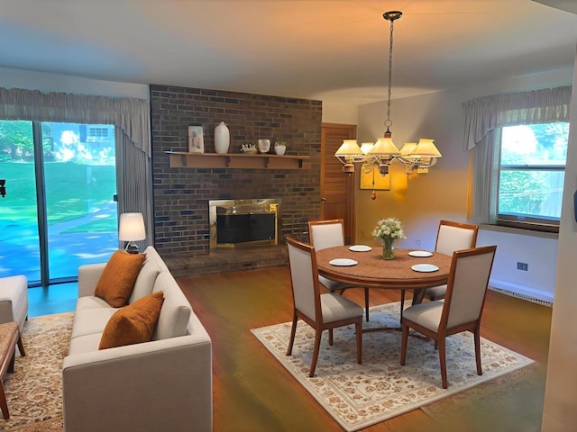 9035 W Burdick Ave, Milwaukee, WI 53227 - dining space featuring a chandelier, plenty of natural light, wood finished floors, and a baseboard radiator