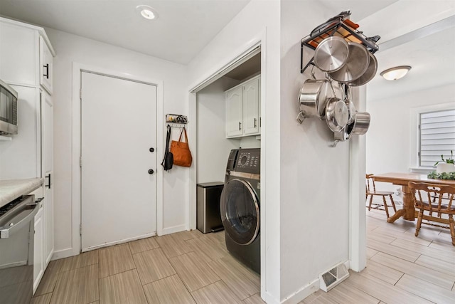 266 E 10th St, Fond Du Lac, WI 54935 - laundry area with washer / clothes dryer, wood finish floors, and cabinet space