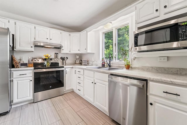 266 E 10th St, Fond Du Lac, WI 54935 - kitchen featuring stainless steel appliances, under cabinet range hood, and white cabinetry