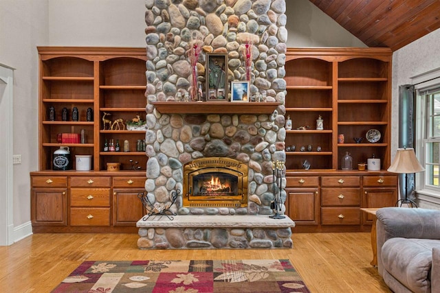 704 Sandy Pines Ct, Redgranite, WI 54970 - living room featuring light wood finished floors, a stone fireplace, vaulted ceiling, and wood ceiling
