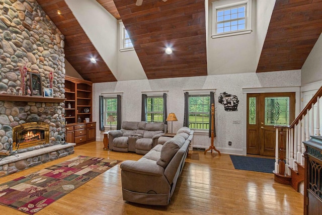 704 Sandy Pines Ct, Redgranite, WI 54970 - living room with high vaulted ceiling, hardwood / wood-style flooring, plenty of natural light, a stone fireplace, and wood ceiling