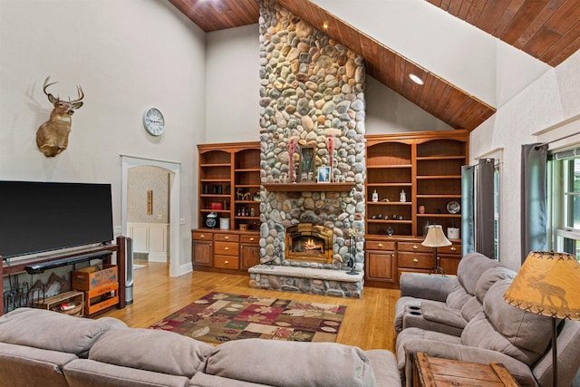 704 Sandy Pines Ct, Redgranite, WI 54970 - living area with high vaulted ceiling, a wood ceiling with exposed beams, a fireplace, and light wood-style flooring