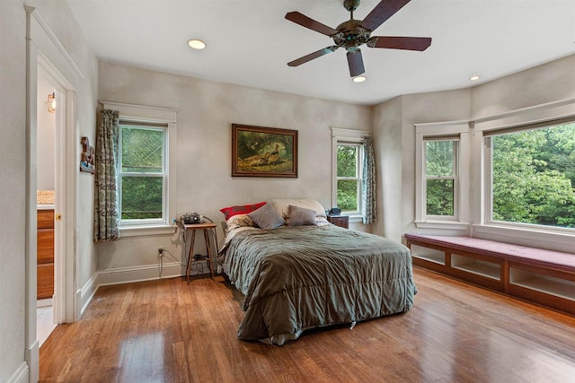 704 Sandy Pines Ct, Redgranite, WI 54970 - bedroom featuring multiple windows, light wood-style floors, recessed lighting, and ceiling fan