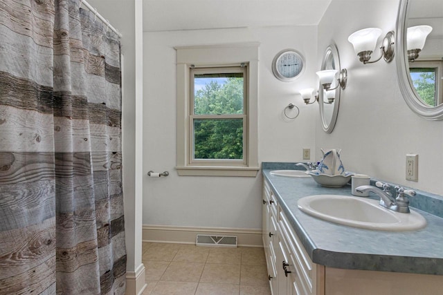 704 Sandy Pines Ct, Redgranite, WI 54970 - bathroom featuring tile patterned flooring, double vanity, and healthy amount of natural light