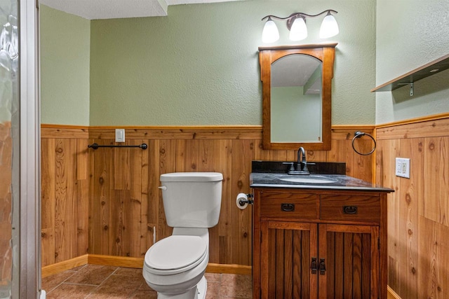 704 Sandy Pines Ct, Redgranite, WI 54970 - bathroom with wood walls, vanity, and a wainscoted wall