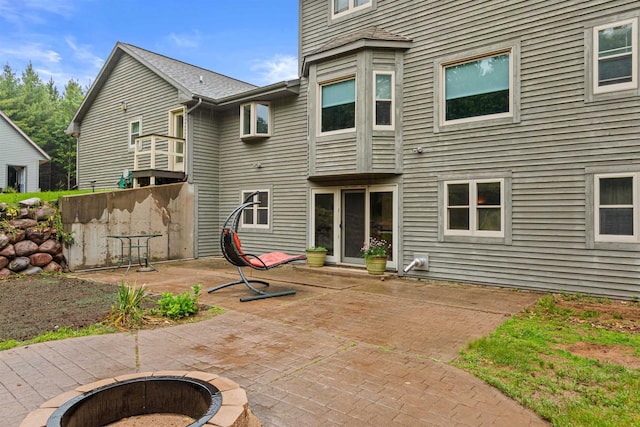 704 Sandy Pines Ct, Redgranite, WI 54970 - back of property with a fire pit and a patio area