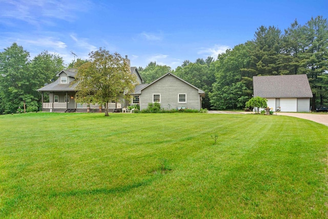 704 Sandy Pines Ct, Redgranite, WI 54970 - view of green lawn with covered porch, an outdoor structure, and a garage