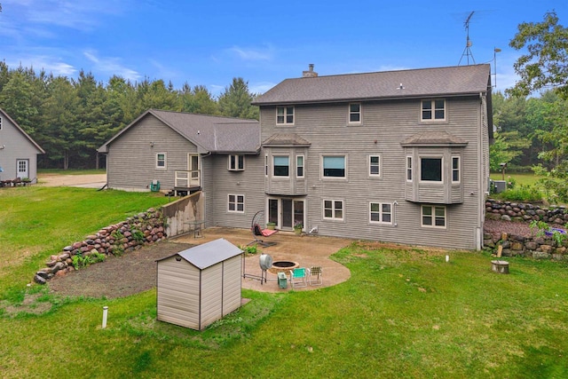 704 Sandy Pines Ct, Redgranite, WI 54970 - back of property with a fire pit, a patio, a yard, and a chimney