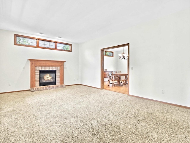 4315 Tanglewood Dr, Janesville, WI 53546 - unfurnished living room featuring carpet floors, a chandelier, and a fireplace