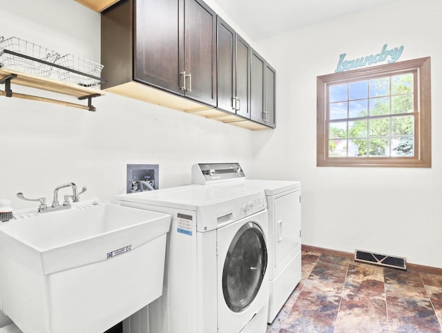 4315 Tanglewood Dr, Janesville, WI 53546 - washroom featuring independent washer and dryer, cabinet space, and stone finish floors