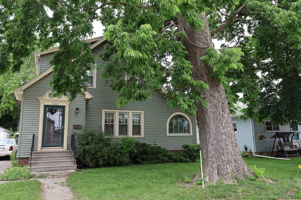 1332 Waugoo Ave, Oshkosh, WI 54901 - obstructed view of property featuring a front yard