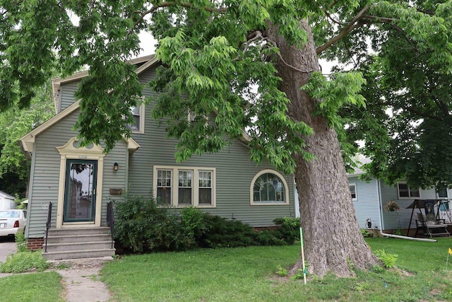 1332 Waugoo Ave, Oshkosh, WI 54901 - obstructed view of property featuring a front yard