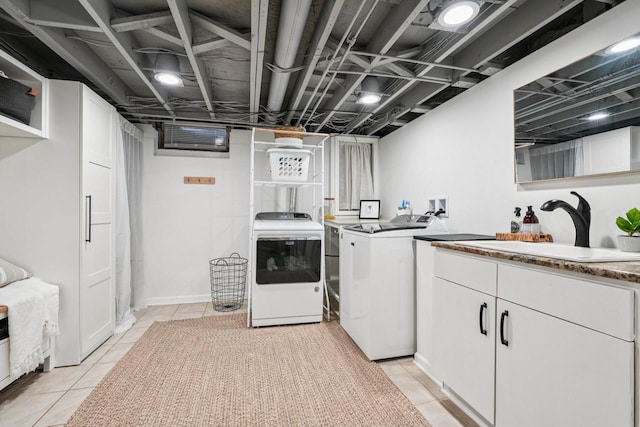 235 Jasper Ln, Waukesha, WI 53188 - washroom with independent washer and dryer, light tile patterned flooring, and cabinet space