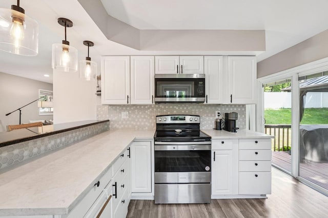 235 Jasper Ln, Waukesha, WI 53188 - kitchen featuring appliances with stainless steel finishes, wood finished floors, tasteful backsplash, and white cabinetry