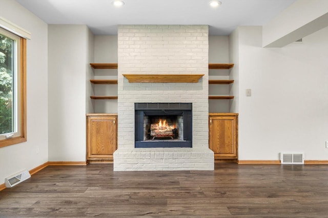 8206 41st Ave, Kenosha, WI 53142 - unfurnished living room featuring a brick fireplace, dark wood finished floors, and recessed lighting