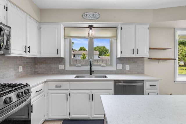 8206 41st Ave, Kenosha, WI 53142 - kitchen with appliances with stainless steel finishes, light countertops, white cabinets, and tasteful backsplash