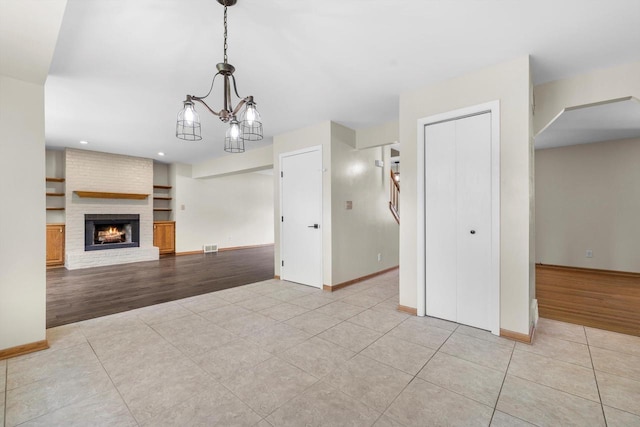 8206 41st Ave, Kenosha, WI 53142 - unfurnished living room with tile patterned floors, a fireplace, arched walkways, and recessed lighting