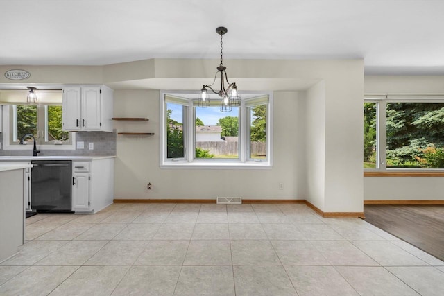 8206 41st Ave, Kenosha, WI 53142 - kitchen featuring dishwasher, light countertops, and plenty of natural light