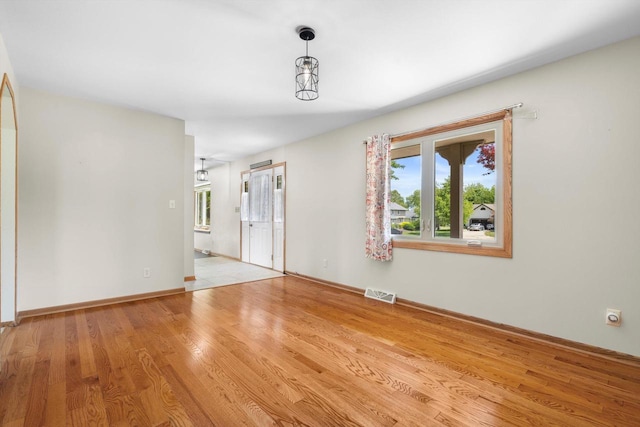 8206 41st Ave, Kenosha, WI 53142 - empty room with healthy amount of natural light and wood finished floors