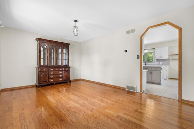 8206 41st Ave, Kenosha, WI 53142 - spare room featuring arched walkways and light wood-style flooring