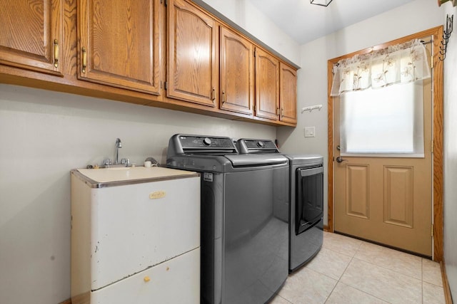 8206 41st Ave, Kenosha, WI 53142 - washroom with washer and dryer, cabinet space, and light tile patterned floors