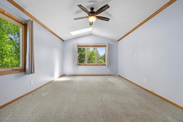 8206 41st Ave, Kenosha, WI 53142 - empty room featuring a skylight, a ceiling fan, lofted ceiling, carpet flooring, and crown molding