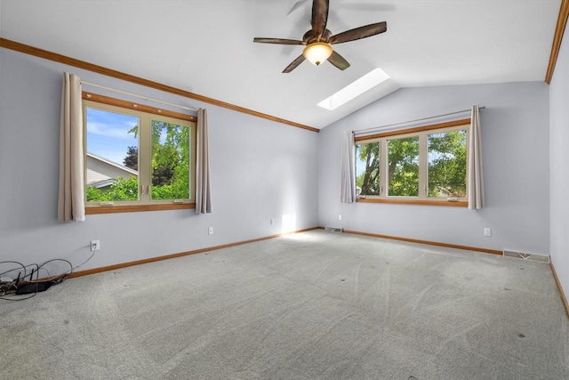 8206 41st Ave, Kenosha, WI 53142 - empty room featuring a skylight, vaulted ceiling, ceiling fan, and carpet flooring