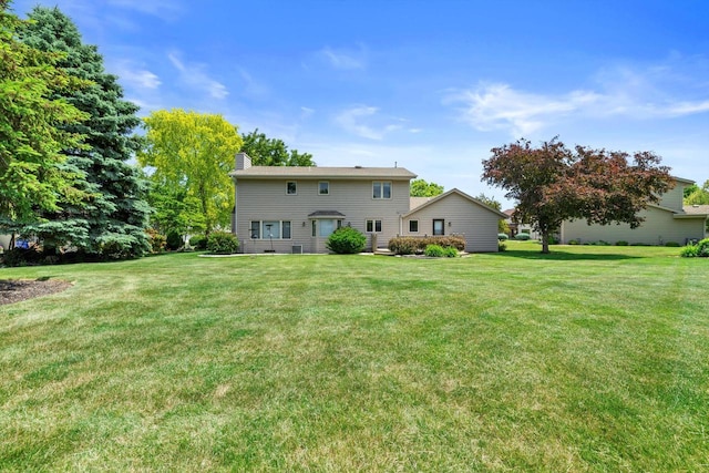 8206 41st Ave, Kenosha, WI 53142 - rear view of property featuring a lawn and a chimney