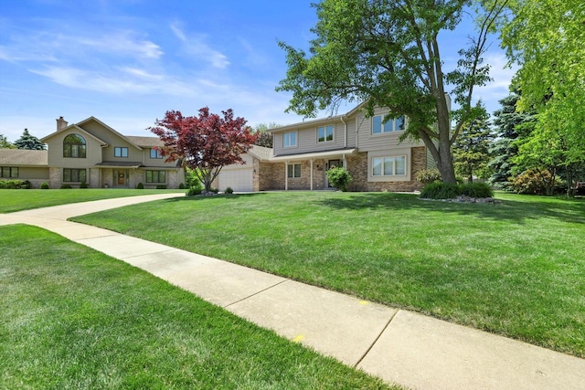 8206 41st Ave, Kenosha, WI 53142 - traditional home featuring a front lawn, an attached garage, and brick siding