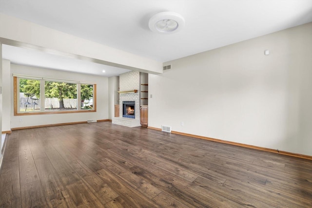 8206 41st Ave, Kenosha, WI 53142 - unfurnished living room featuring dark wood-type flooring and a fireplace
