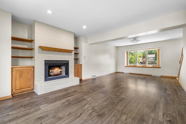 8206 41st Ave, Kenosha, WI 53142 - unfurnished living room with dark wood-style flooring, a fireplace, and recessed lighting
