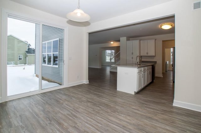 415 Kensington Ct Unit Lt128Adams, Williams Bay, WI 53191 - kitchen featuring dark wood-style floors, open floor plan, hanging light fixtures, and white cabinetry