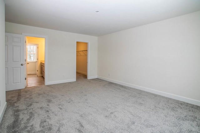 415 Kensington Ct Unit Lt128Adams, Williams Bay, WI 53191 - unfurnished bedroom featuring carpet floors, a walk in closet, and a closet